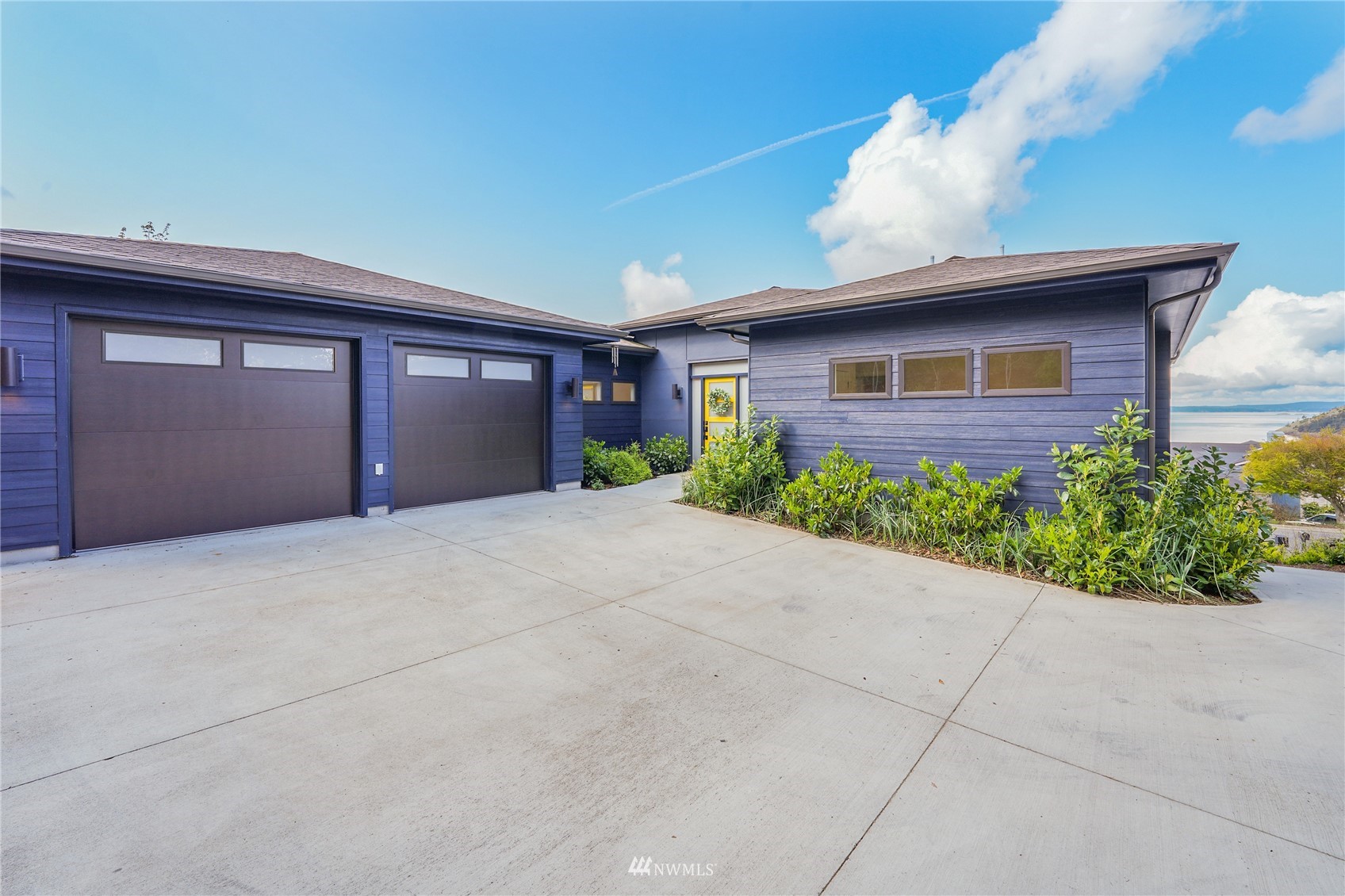 4920 Heather Drive Anacortes, WA 98221 - Photo 3 of 40 a front view of a house with a yard and garage