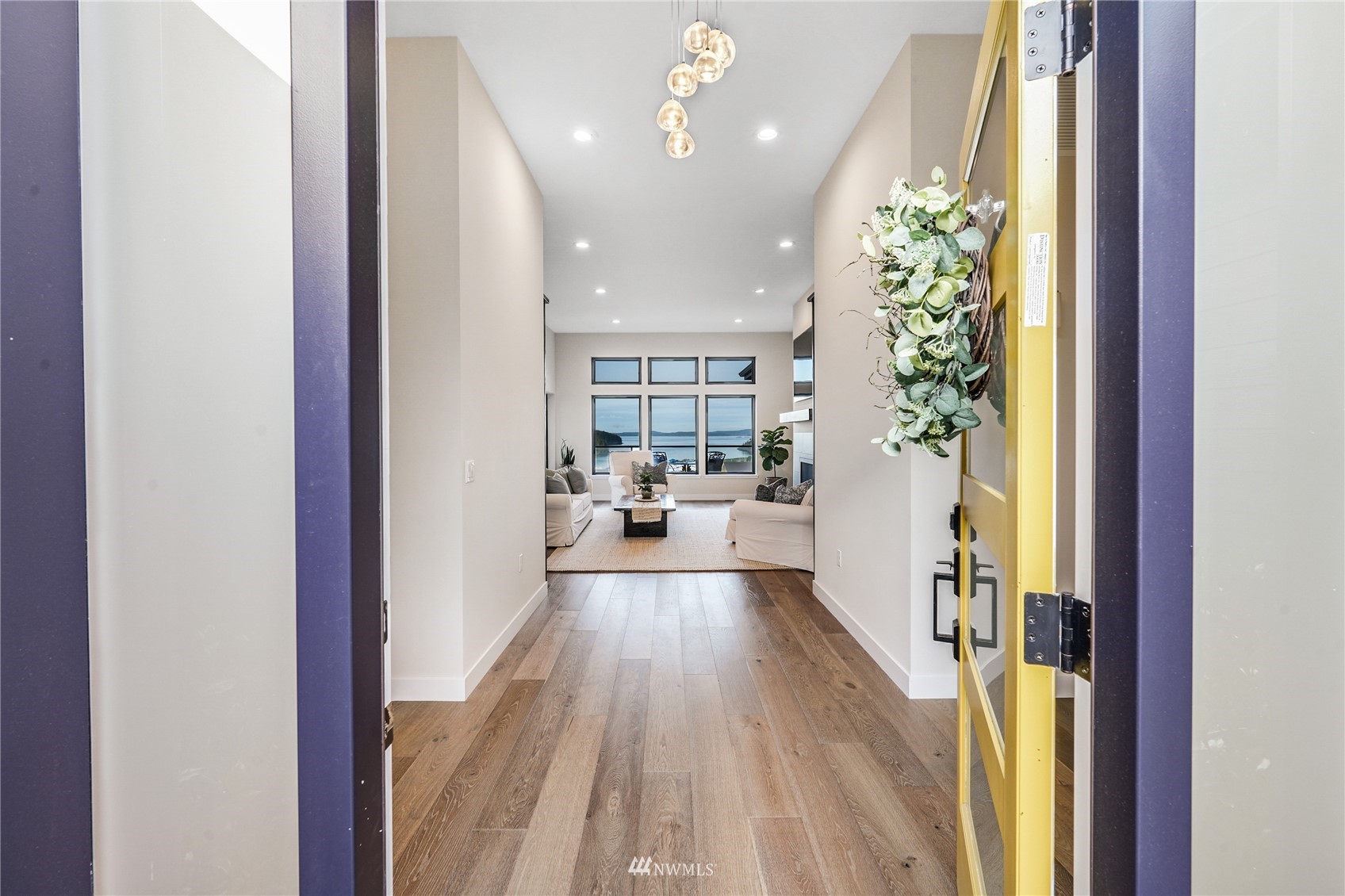 4920 Heather Drive Anacortes, WA 98221 - Photo 4 of 40 en view of a hallway with wooden floor and a living room