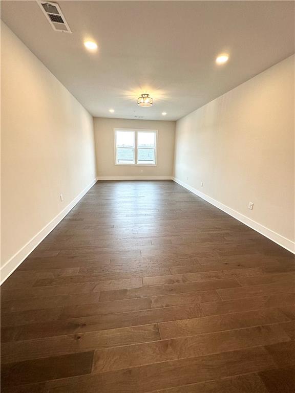 1237 Waldon Crossing Cumming, GA 30041 - Photo 22 of 29 an empty room with wooden floor and windows