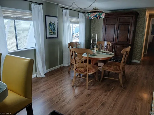 a view of a dining room with furniture and wooden floor