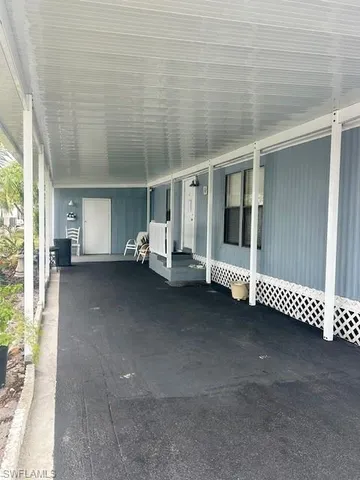 a view of a porch with furniture and garden