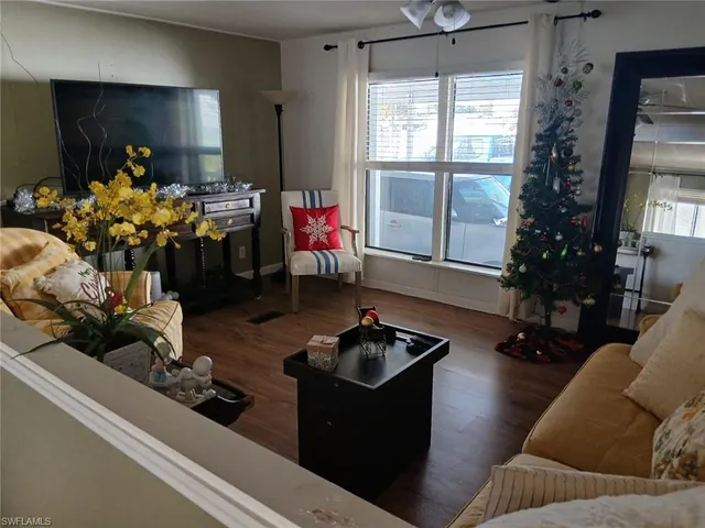 a kitchen with stainless steel appliances a table and chairs