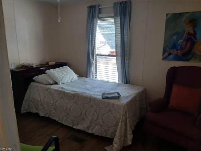 a bed sitting in a bedroom next to a window