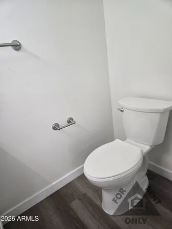 a white toilet sitting next to a sink