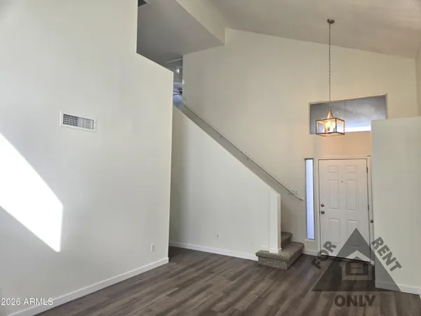 a view of a room with wooden floor and staircase