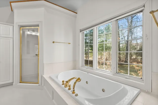 a bathroom with a tub and shower