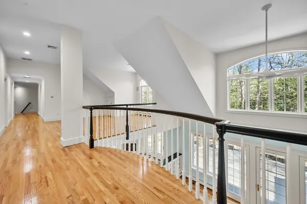 a view of entryway and hall with wooden floor