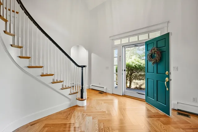 a view of an entryway with wooden floor and stairs