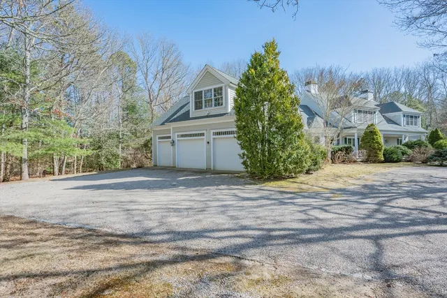 a front view of a house with a yard and trees