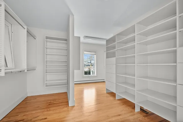 a view of a room with wooden floor and white walls