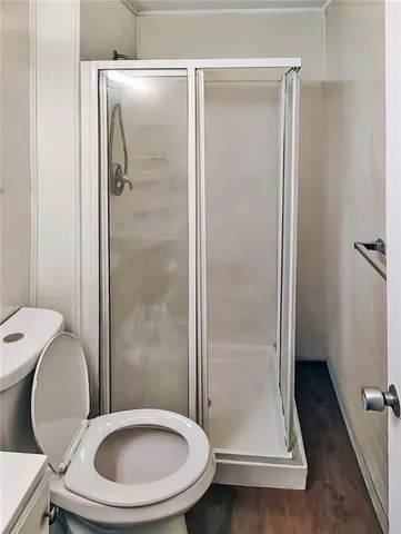 a bathroom with a toilet and a shower