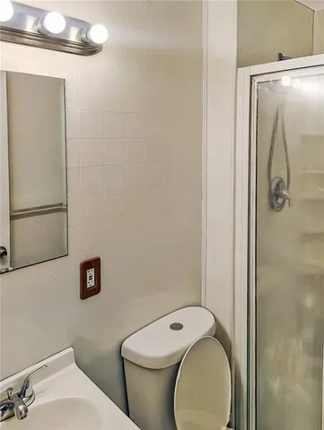 a white toilet sitting next to a bathroom sink