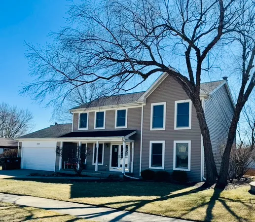 a view of a house with a large tree
