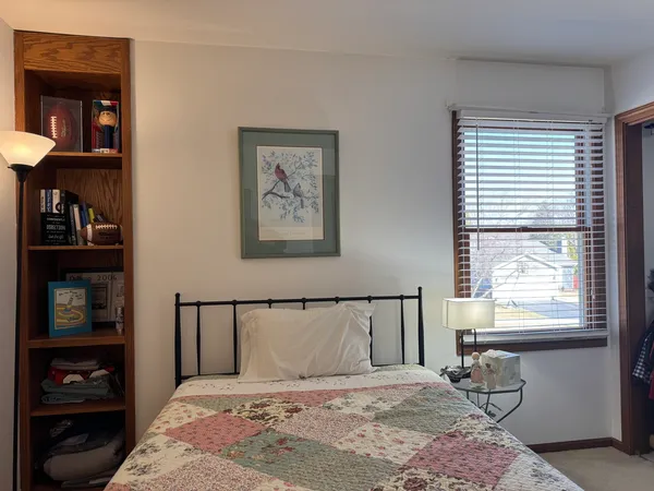 a bedroom with a large bed and a window