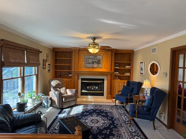 a living room with furniture a window and a fireplace