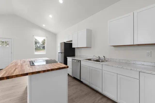a kitchen with sink cabinets and microwave