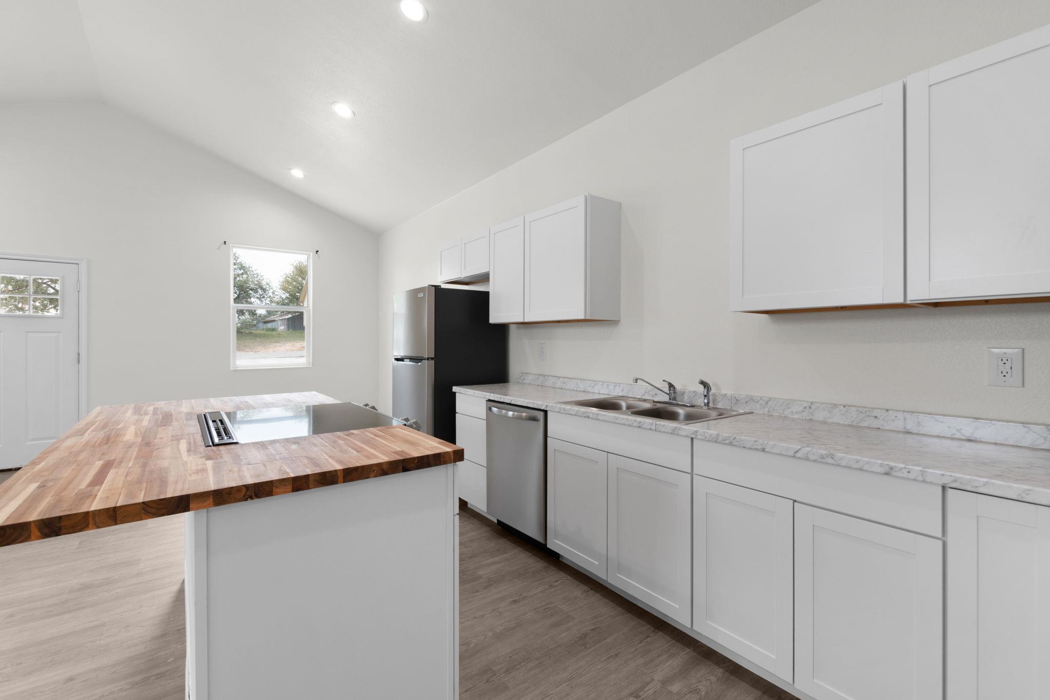870 Waco Street Kingsland, TX 78639 - Photo 12 of 30 a kitchen with sink cabinets and microwave