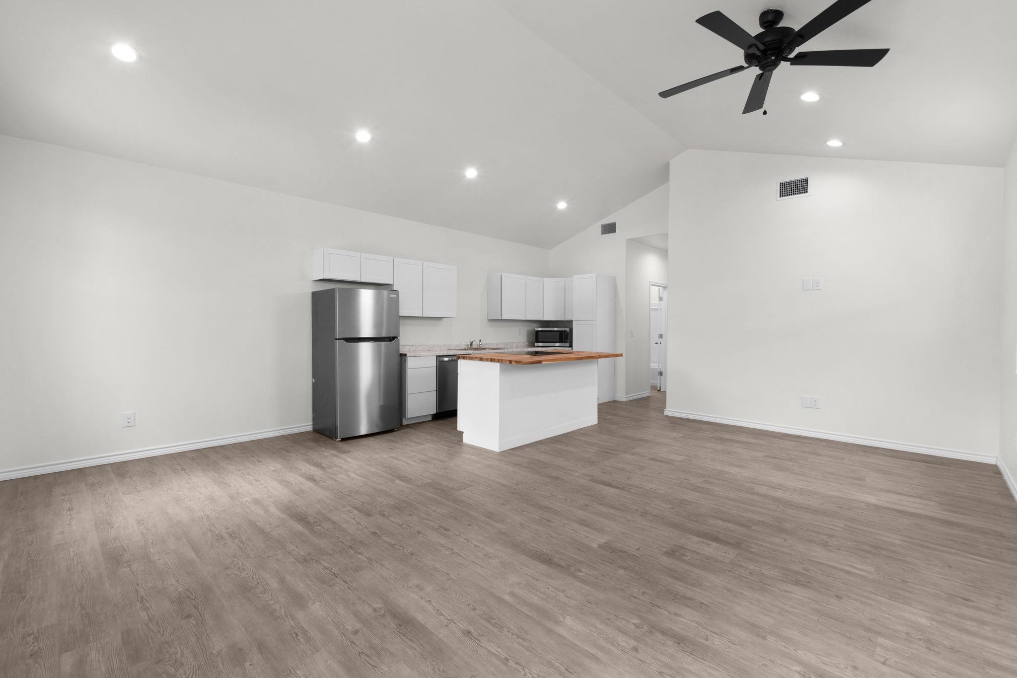 870 Waco Street Kingsland, TX 78639 - Photo 13 of 30 a view of kitchen with stainless steel appliances a refrigerator and a microwave