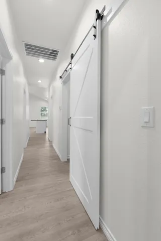 a view of storage and utility room with wooden floor