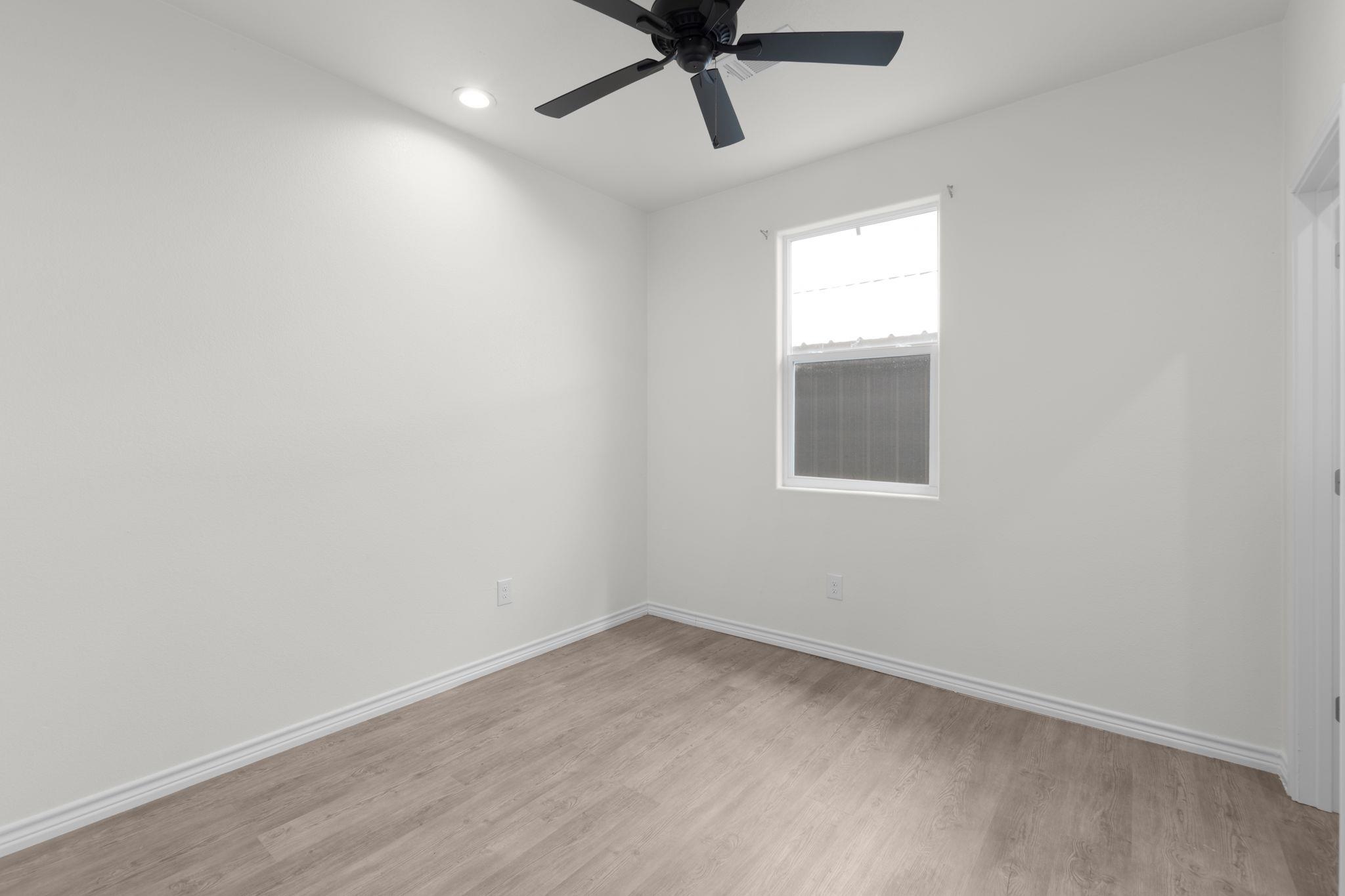 870 Waco Street Kingsland, TX 78639 - Photo 18 of 30 an empty room with a window and a fan