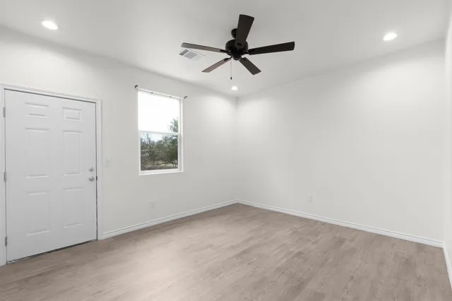wooden floor in an empty room with a window
