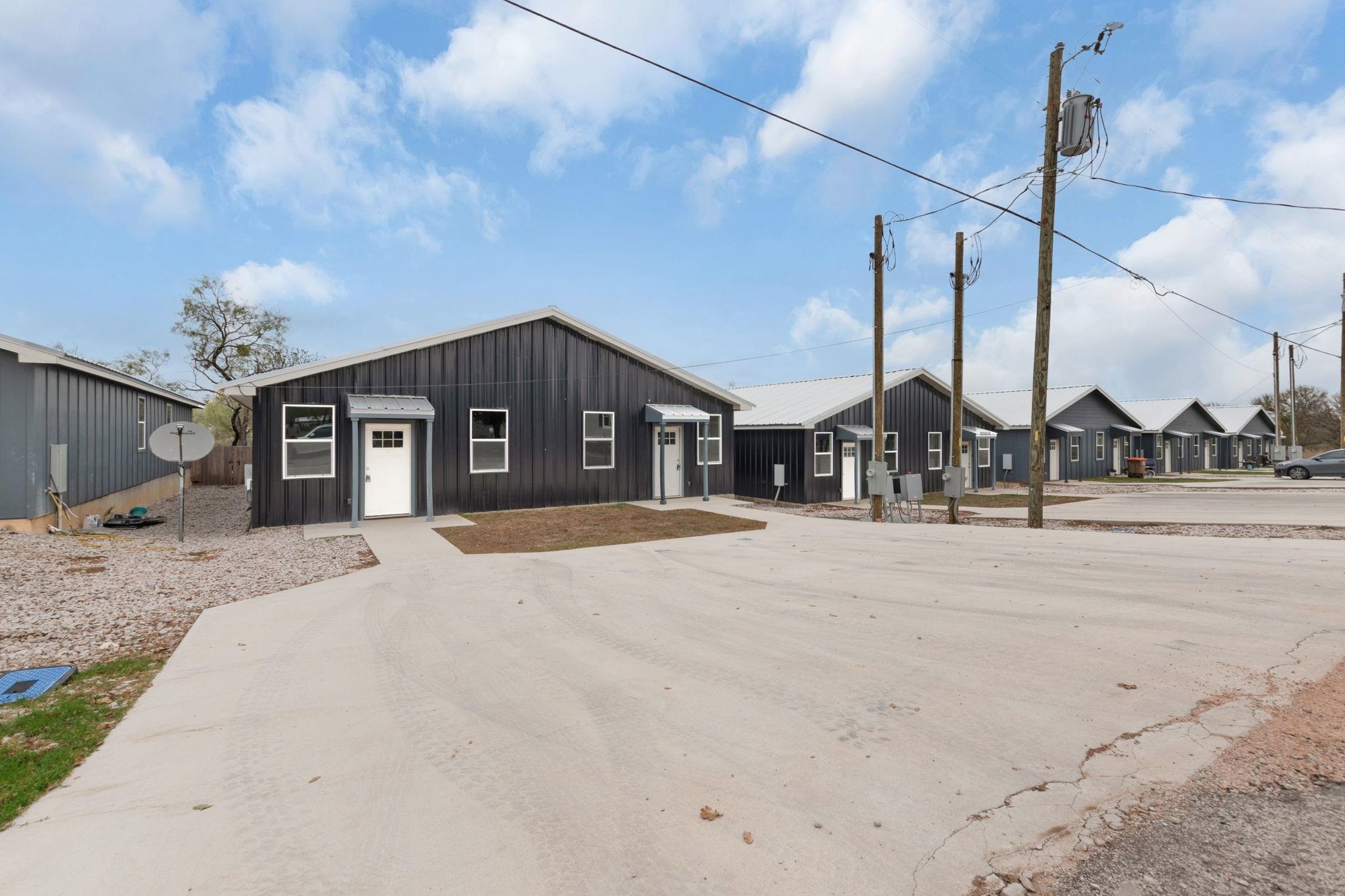 870 Waco Street Kingsland, TX 78639 - Photo 3 of 30 a front view of a house with a outdoor space