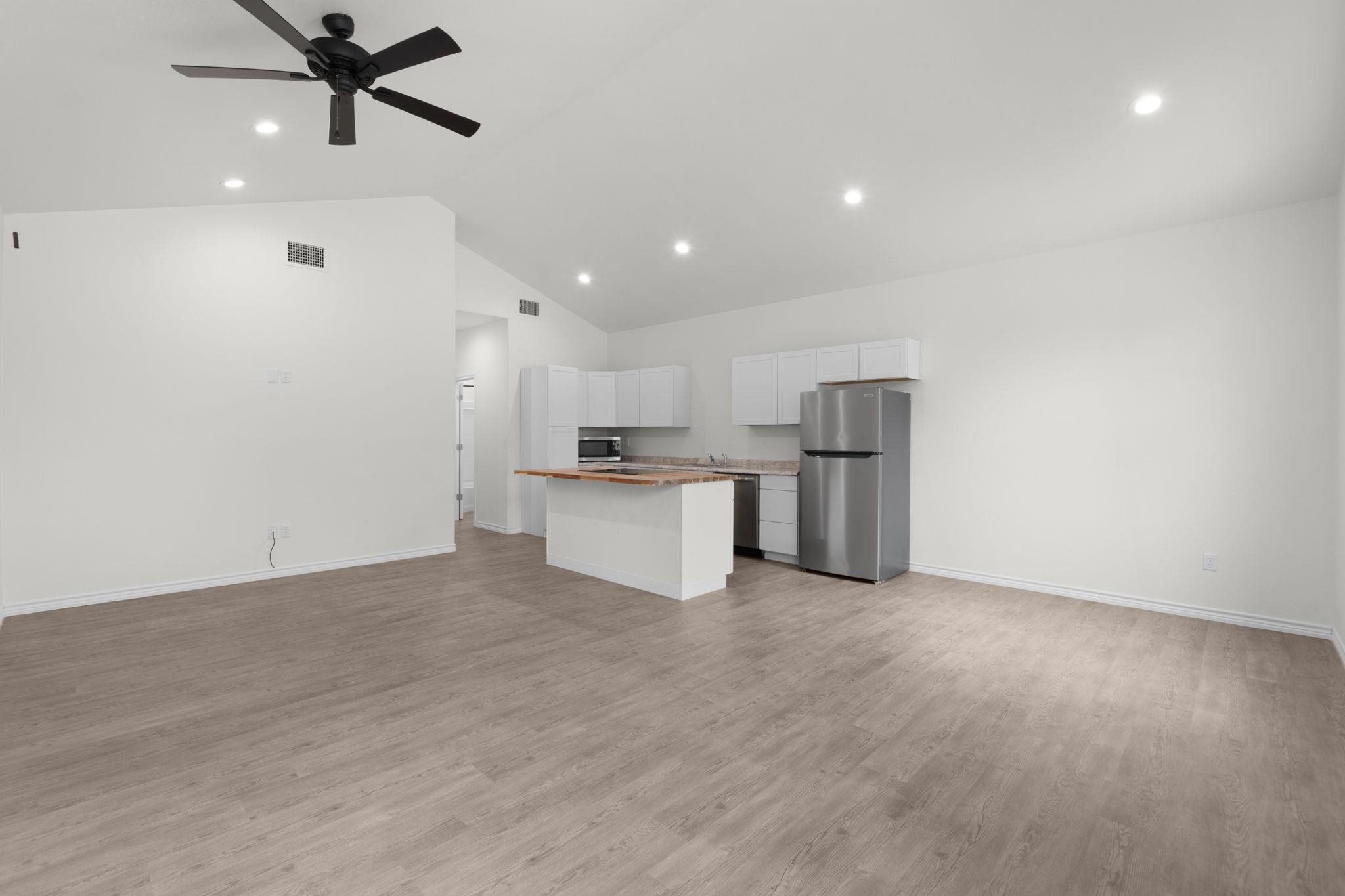 870 Waco Street Kingsland, TX 78639 - Photo 5 of 30 a view of kitchen with stainless steel appliances refrigerator oven and stove