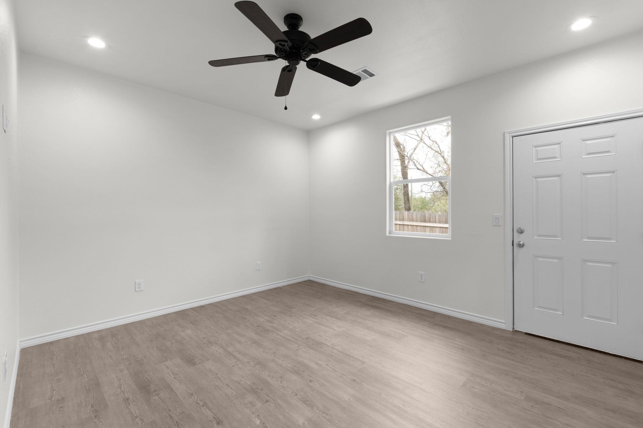 870 Waco Street Kingsland, TX 78639 - Photo 7 of 30 an empty room with a window and a fan