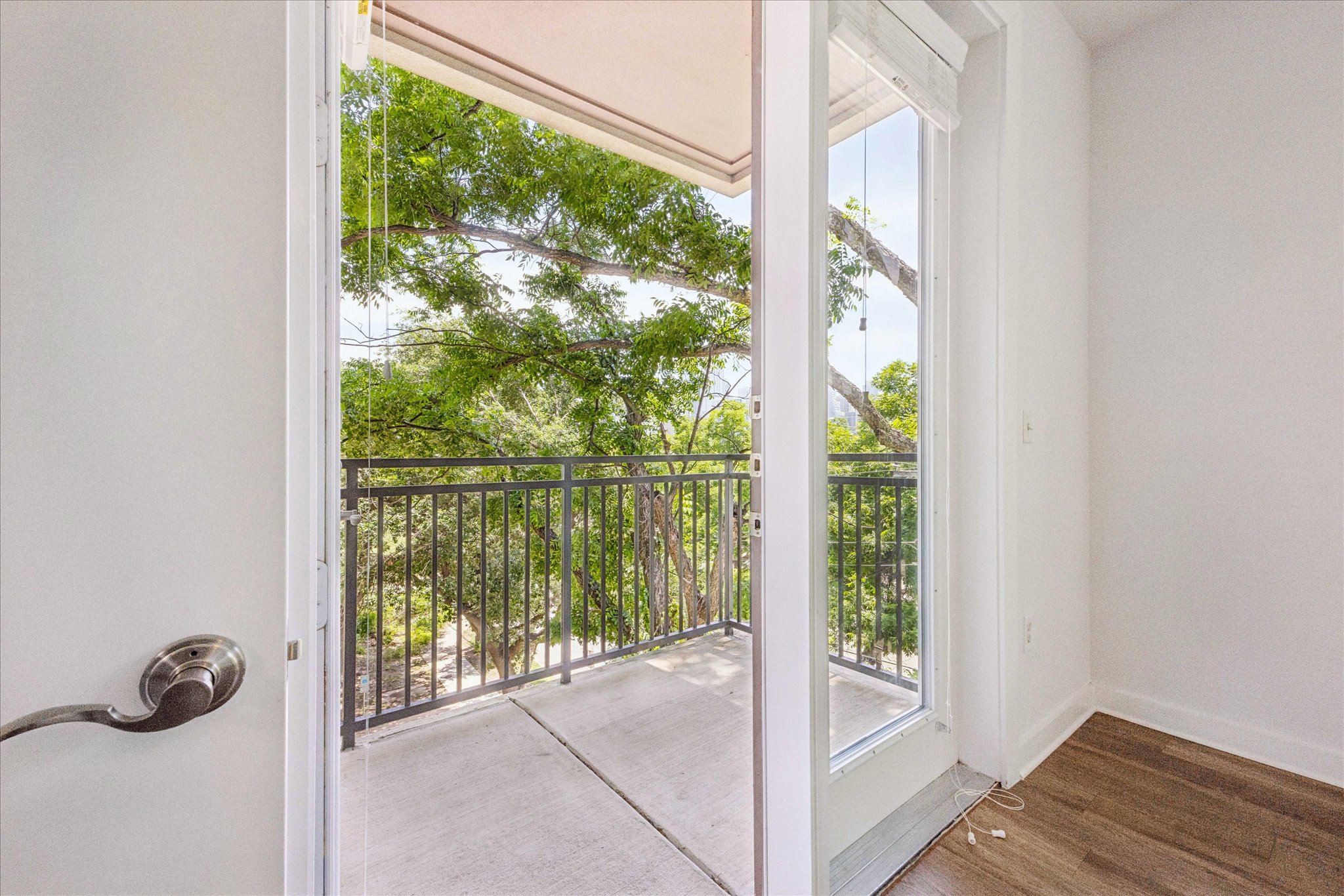 1900 Barton Springs Road, Unit 4041 Austin, TX 78704 - Photo 5 of 35 A private balcony extends the living space, offering tranquil tree-filled views.