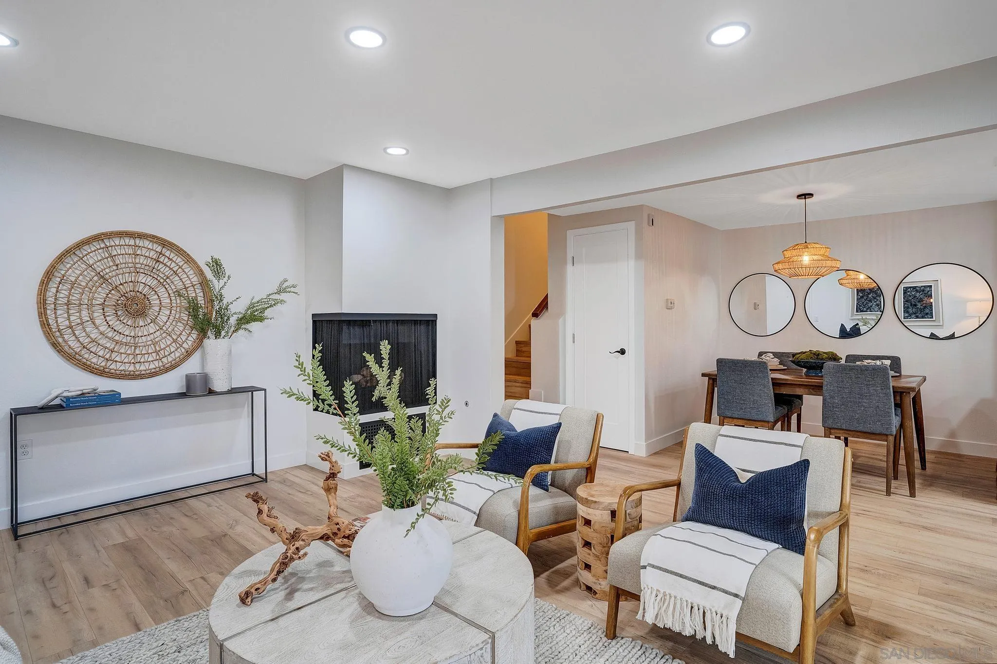 a living room with furniture a mirror and a fireplace