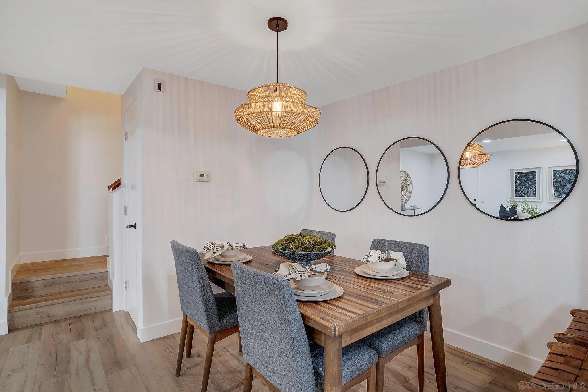 1344 Caminito Septimo Cardiff, CA 92007 - Photo 7 of 10 a view of a dining room with furniture a chandelier and wooden floor