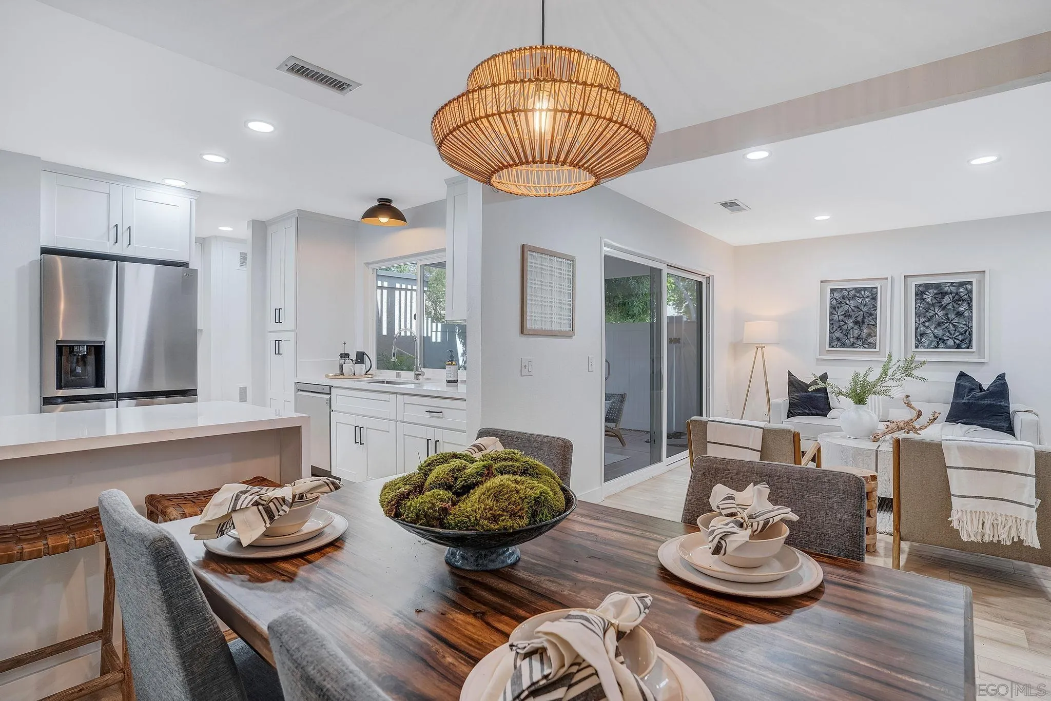1344 Caminito Septimo Cardiff, CA 92007 - Photo 8 of 10 a kitchen with stainless steel appliances a table and chairs