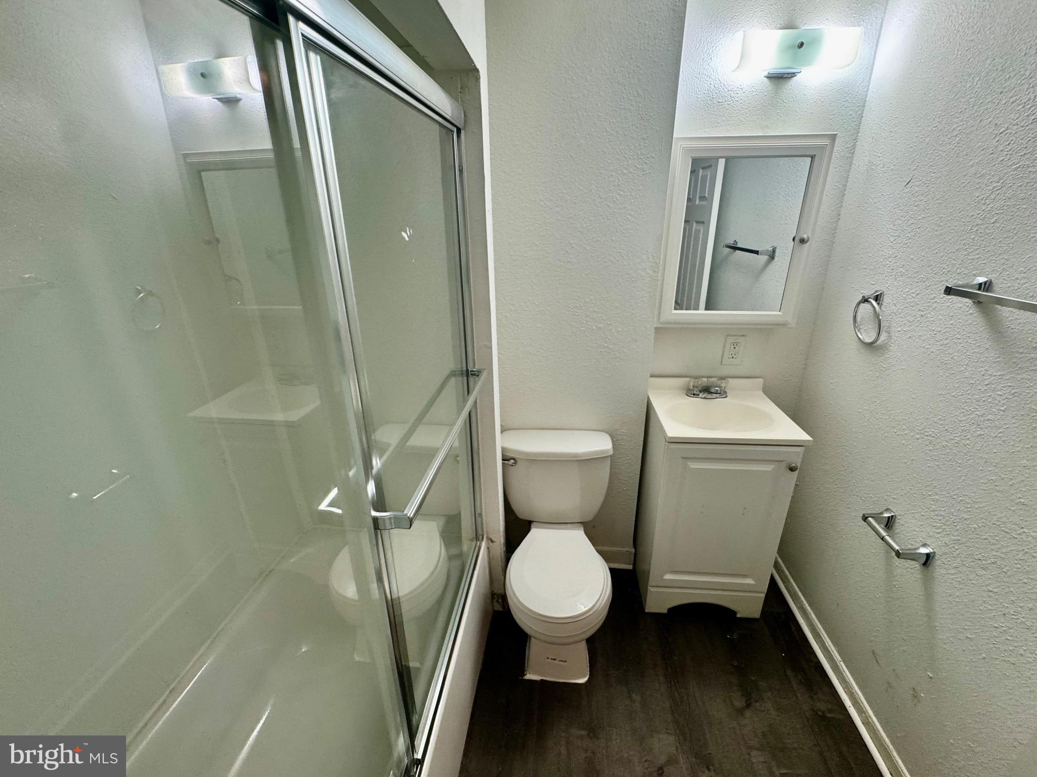 2012 Cliftwood Avenue Baltimore, MD 21213 - Photo 15 of 25 a white toilet sitting next to a bathroom sink and a shower