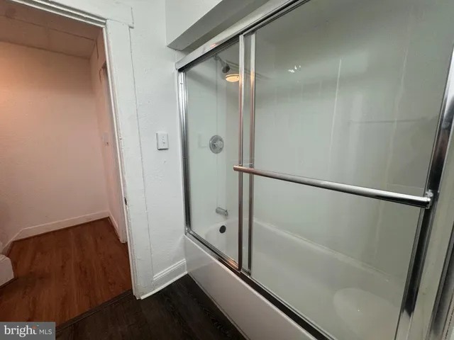 a bathroom with a shower and a mirror