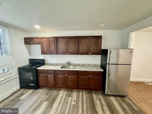 a kitchen with wooden cabinets and a refrigerator