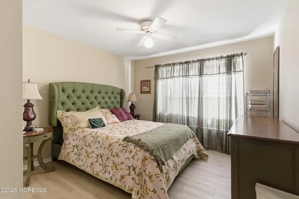 a bed sitting in a bedroom next to a wooden cabinet