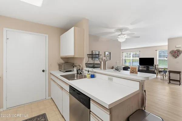 a kitchen with a sink a stove and chairs