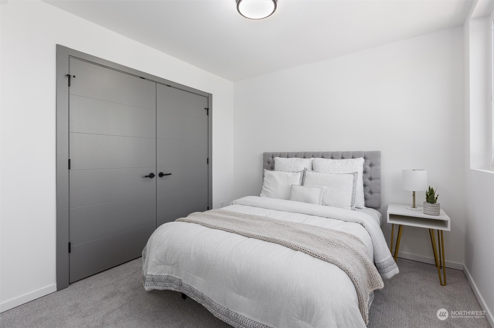 2605 Southwest Nevada Street Seattle, WA 98126 - Photo 16 of 24 a bedroom with a bed and a table