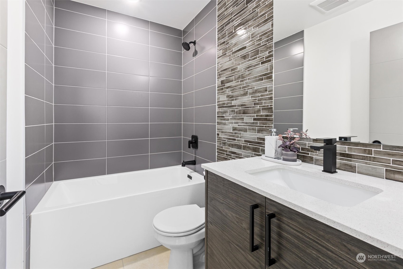 2605 Southwest Nevada Street Seattle, WA 98126 - Photo 18 of 24 a bathroom with a sink a toilet a mirror and bathtub