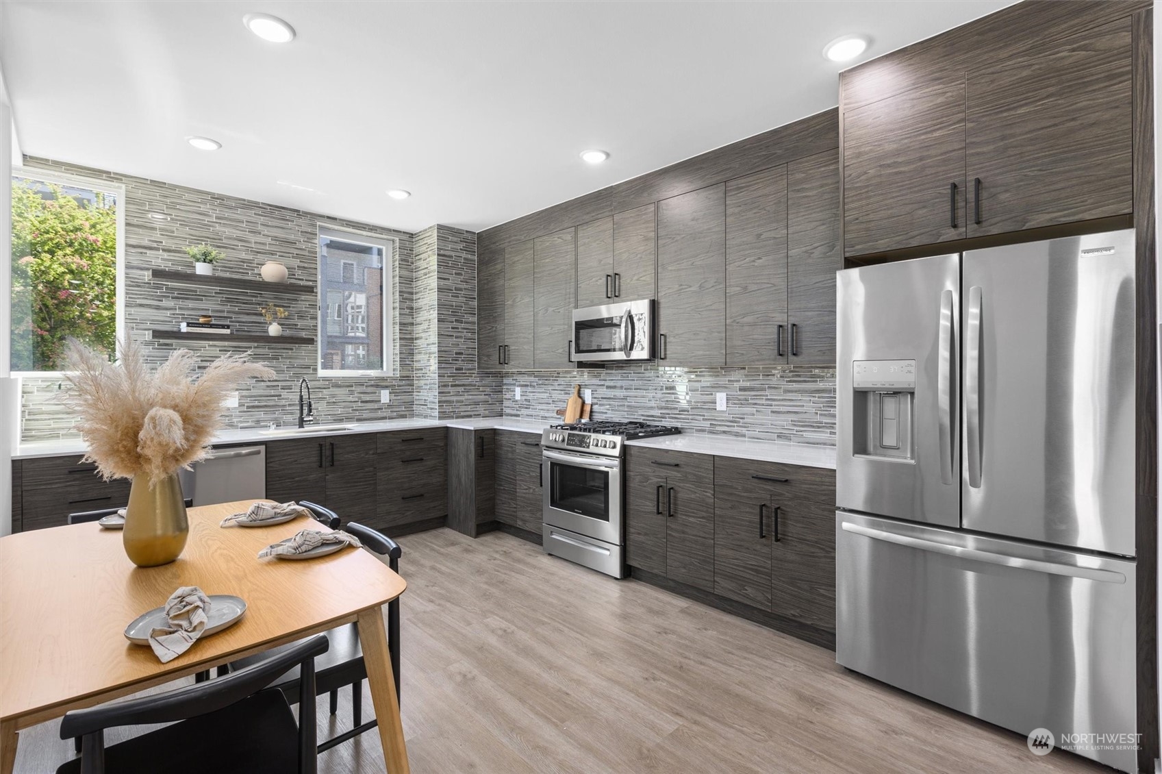 2605 Southwest Nevada Street Seattle, WA 98126 - Photo 4 of 24 a kitchen with stainless steel appliances a stove a sink a refrigerator and a refrigerator