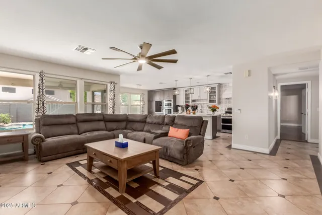 a living room with furniture a view of bedroom and a window