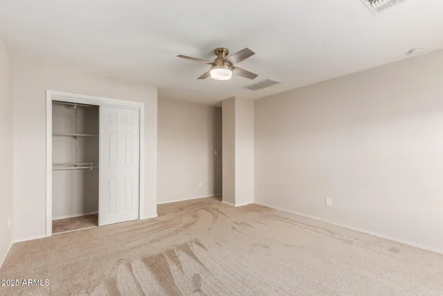 a view of a livingroom with a ceiling fan & a ceiling fan