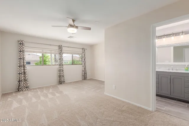 an empty room with windows and entrance door