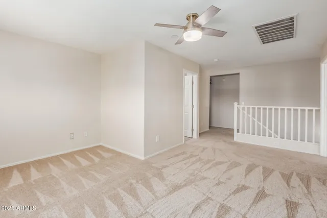 a view of a room with a ceiling fan