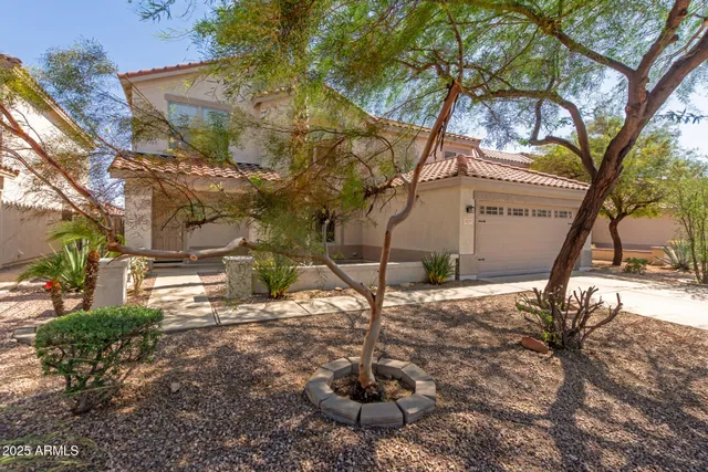 a backyard of a house with table and chairs