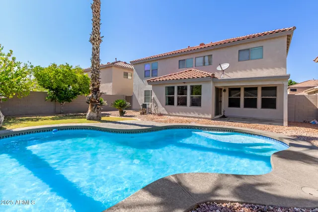 a view of a house with swimming pool and porch