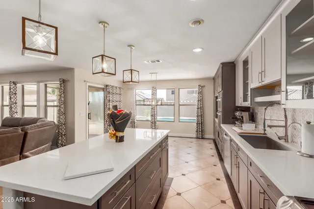 a kitchen with stainless steel appliances a sink a stove and a refrigerator