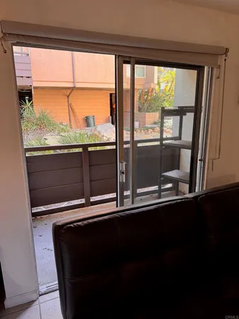 a view of a room with wooden floor and a window