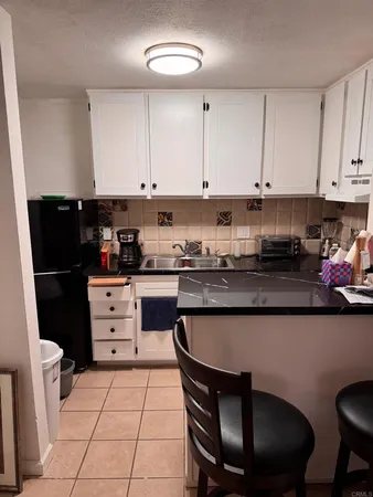 a kitchen with a stove a sink and a refrigerator