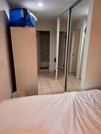 a bedroom with a bed and a mirror
